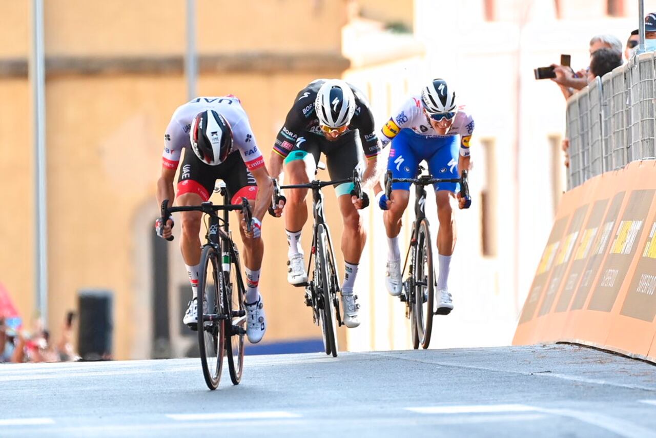 Italy's Diego Ulissi, left, sprints ahead of Slovakia's Peter Sagan and Denmark Mikkel Honore to win the second stage of the Giro d'Italia cycling race, from Alcamo to Agrigento, in Sicily, southern Italy, Sunday, Oct. 4, 2020. (Gian Mattia D'Alberto/LaPresse via AP)