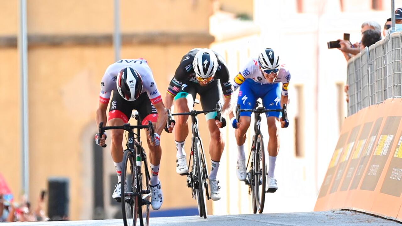 Italy's Diego Ulissi, left, sprints ahead of Slovakia's Peter Sagan and Denmark Mikkel Honore to win the second stage of the Giro d'Italia cycling race, from Alcamo to Agrigento, in Sicily, southern Italy, Sunday, Oct. 4, 2020. (Gian Mattia D'Alberto/LaPresse via AP)