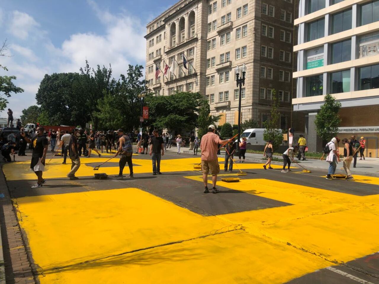 WASHINGTON, DC - JUNE 5: Painters work on a mural on 16th Street in Washington, DC June 5, 2020 before the renaming of the street Black Lives Matter Way in front of St. Johns Church.
(Photo by Toni SandysThe Washington Post via Getty Images)