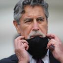 Peru's new interim President Francisco Sagasti takes off his mask after he was designated by Congress to lead the nation, in Lima, Peru, Monday, Nov. 16, 2020. Lawmakers chose Sagasti to become the nation's third president in the span of a week after they ousted Martin Vizcarra and the following protests forced his successor Manuel Merino to resign. (AP Photo/Rodrigo Abd)