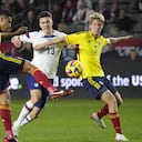 Colombia's Alexis Perez, left, clears the ball in front of United States' Matthew Hoppe (13) and Colombia's Andres Llinas (3) during the second half of an international friendly soccer match Saturday, Jan. 28, 2023, in Carson, Calif. (AP Photo/Marcio Jose Sanchez)