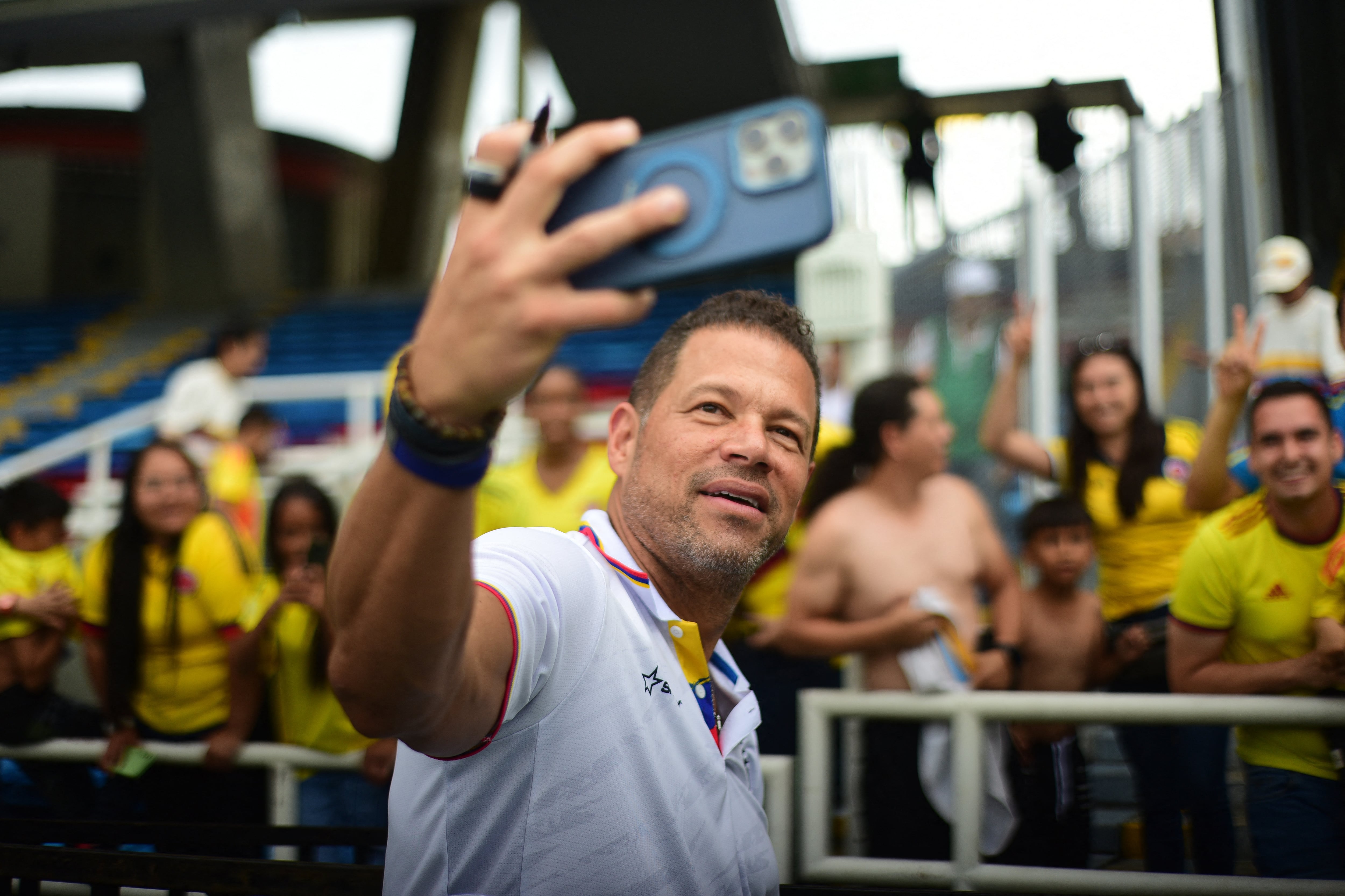 Former Colombian football player Oscar Cordoba takes a selfie with fans ahead of the Legendary Captains match in tribute to Mario Yepes at the Pascual Guerrero stadium in Cali, Colombia on December 20, 2025. (Photo by EDWIN PIPICANO / AFP)