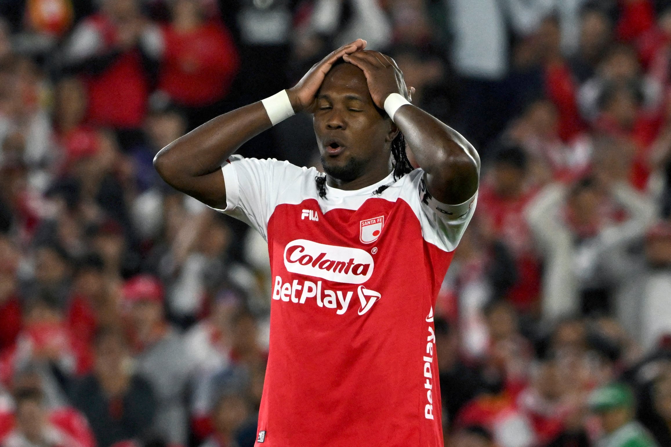 Santa Fe's forward #11 Hugo Rodallega reacts after missing a scoring opportunity during the first leg of the Colombian football championship final between Independiente Santa Fe and Independiente Medellin at the Nemesio Camacho El Campin Stadium in Bogota on June 24, 2025. (Photo by Luis ACOSTA / AFP)