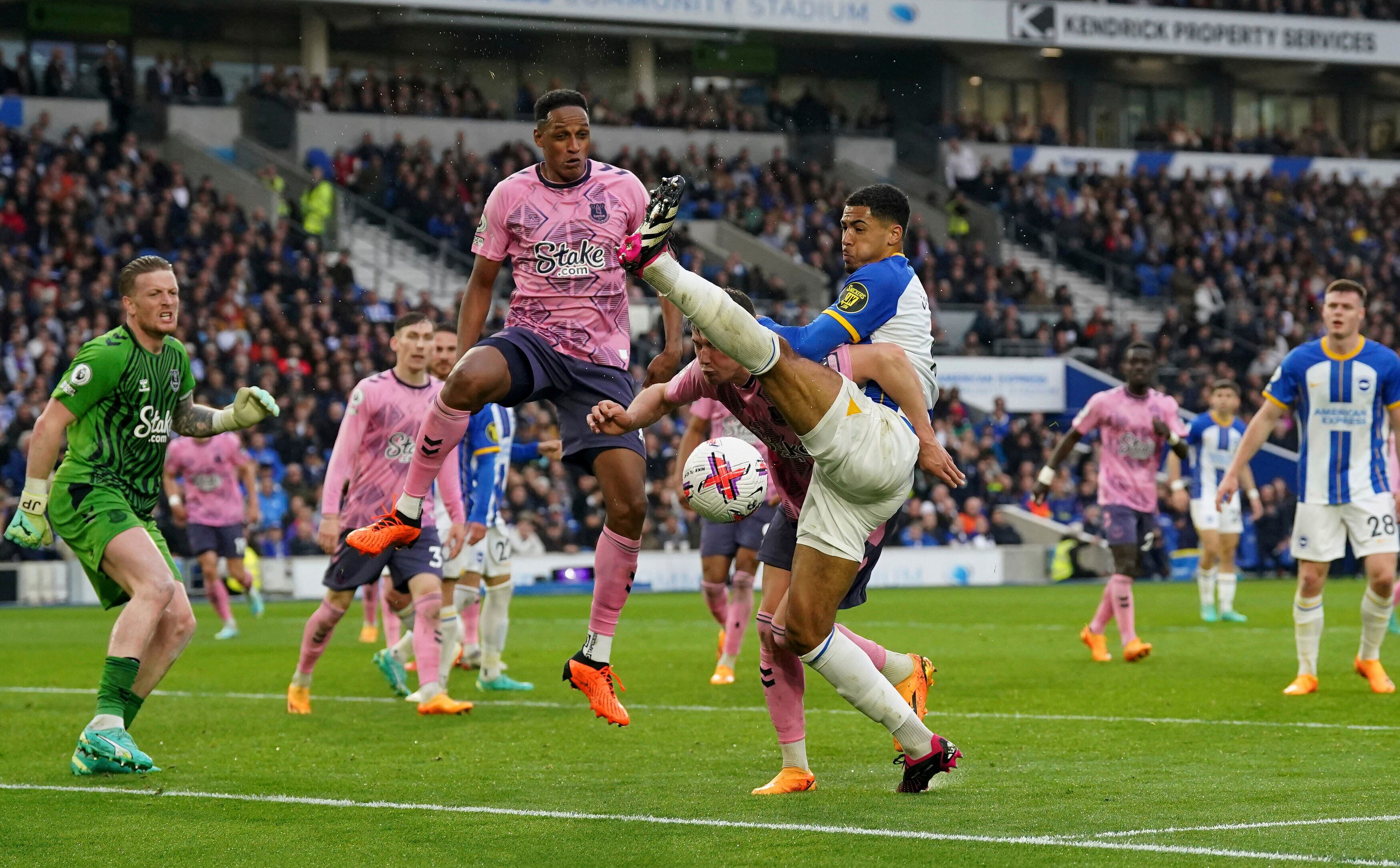 Brighton's Pervis Estupinan, right and Everton's Yerry Mina vie for the ball, during the English Premier League soccer match between Brighton & Hove and Everton, at the AMEX, in Brighton, England, Monday May 8, 2023. (Adam Davy/PA via AP)