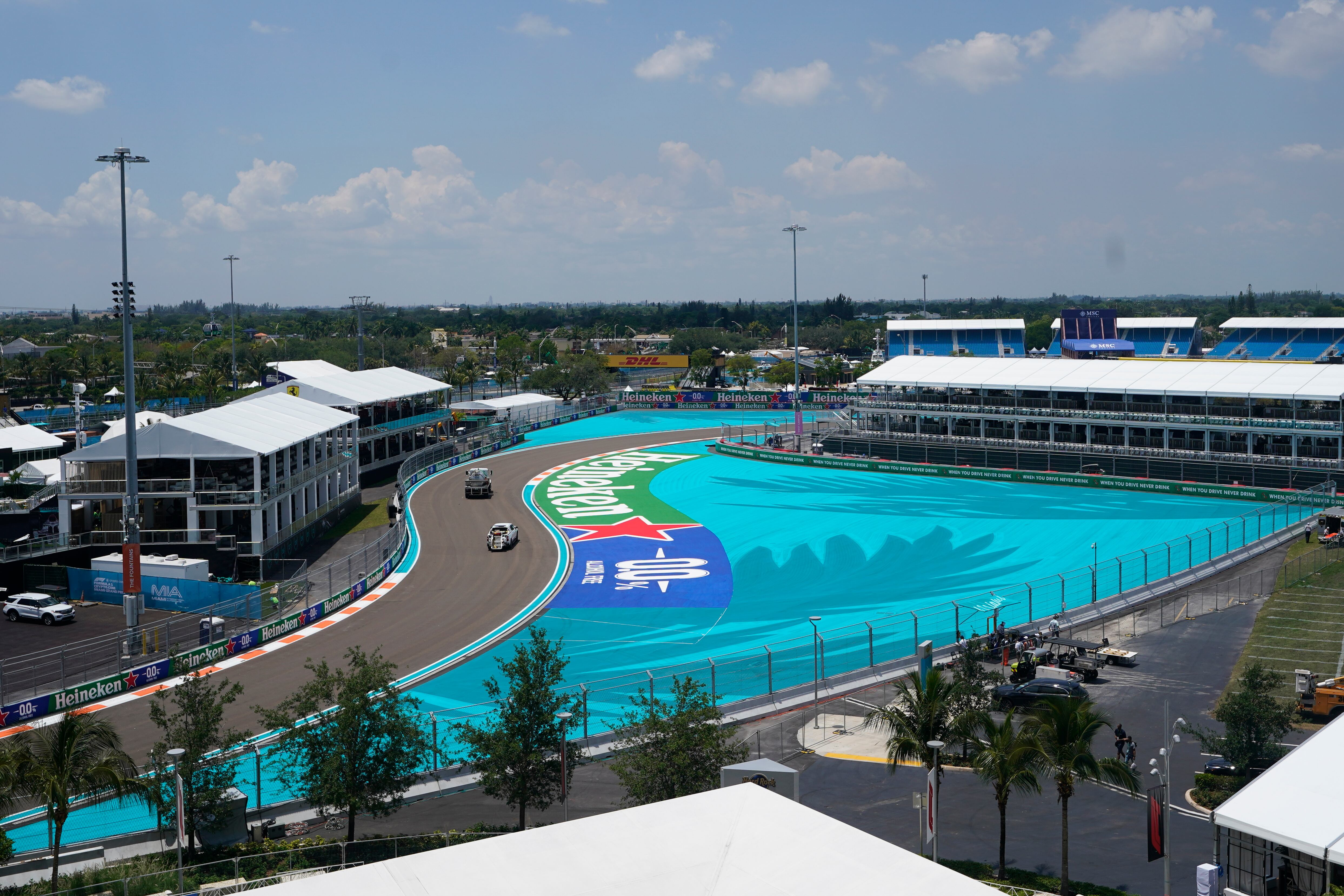 Workers make their way around the Miami International Autodrome in preparation for the Formula One Miami Grand Prix auto race, Thursday, May 5, 2022, in Miami Gardens, Fla. (AP Photo/Darron Cummings)