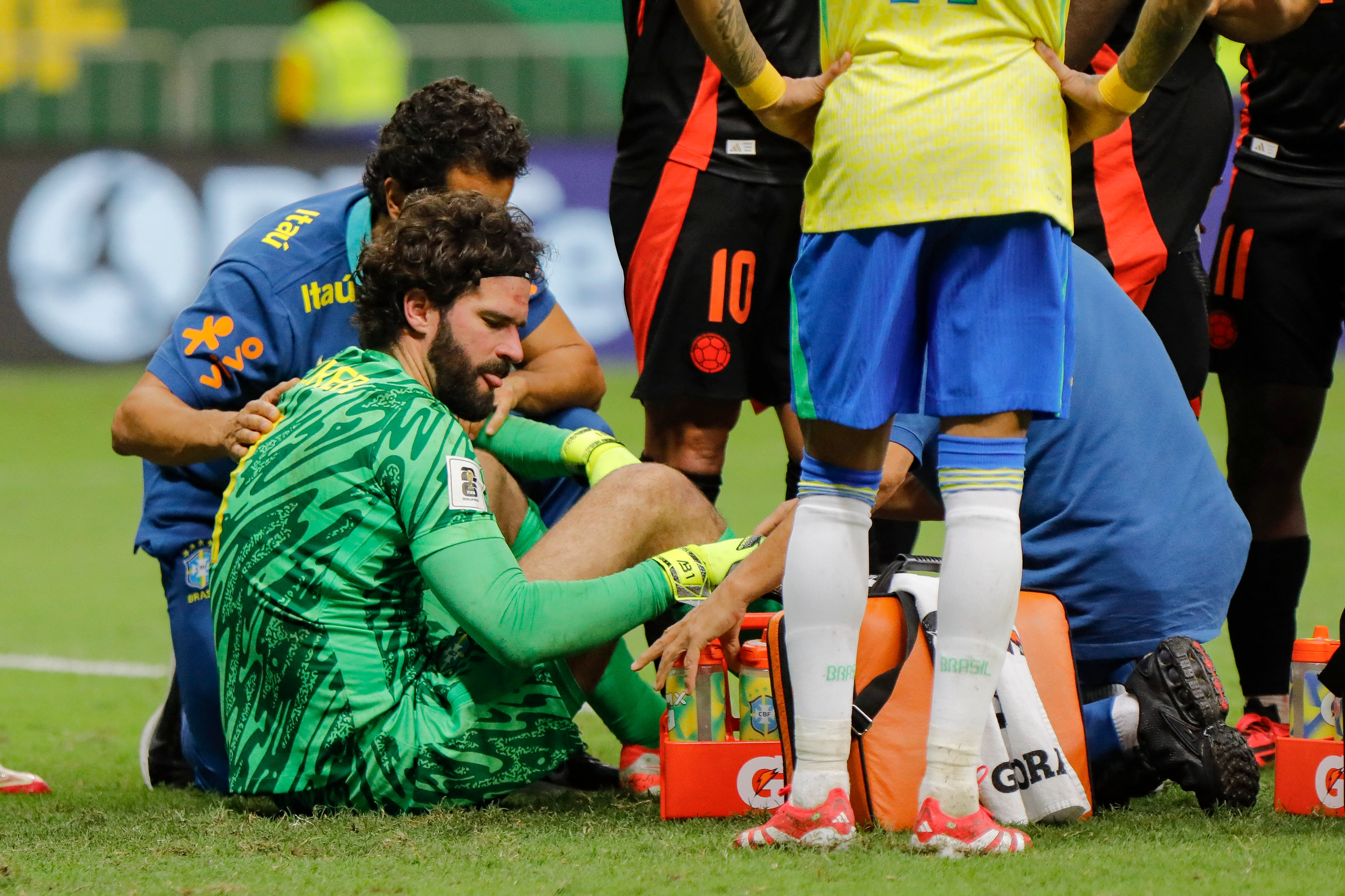 Brazil's goalkeeper #01 Alisson receives medical attention after colliding with Colombia's defender #23 Davinson Sanchez (out of frame) during the 2026 FIFA World Cup South American qualifiers football match between Brazil and Colombia, at the Mane Garrincha stadium in Brasilia, on March 20, 2025. (Photo by Sergio Lima / AFP)