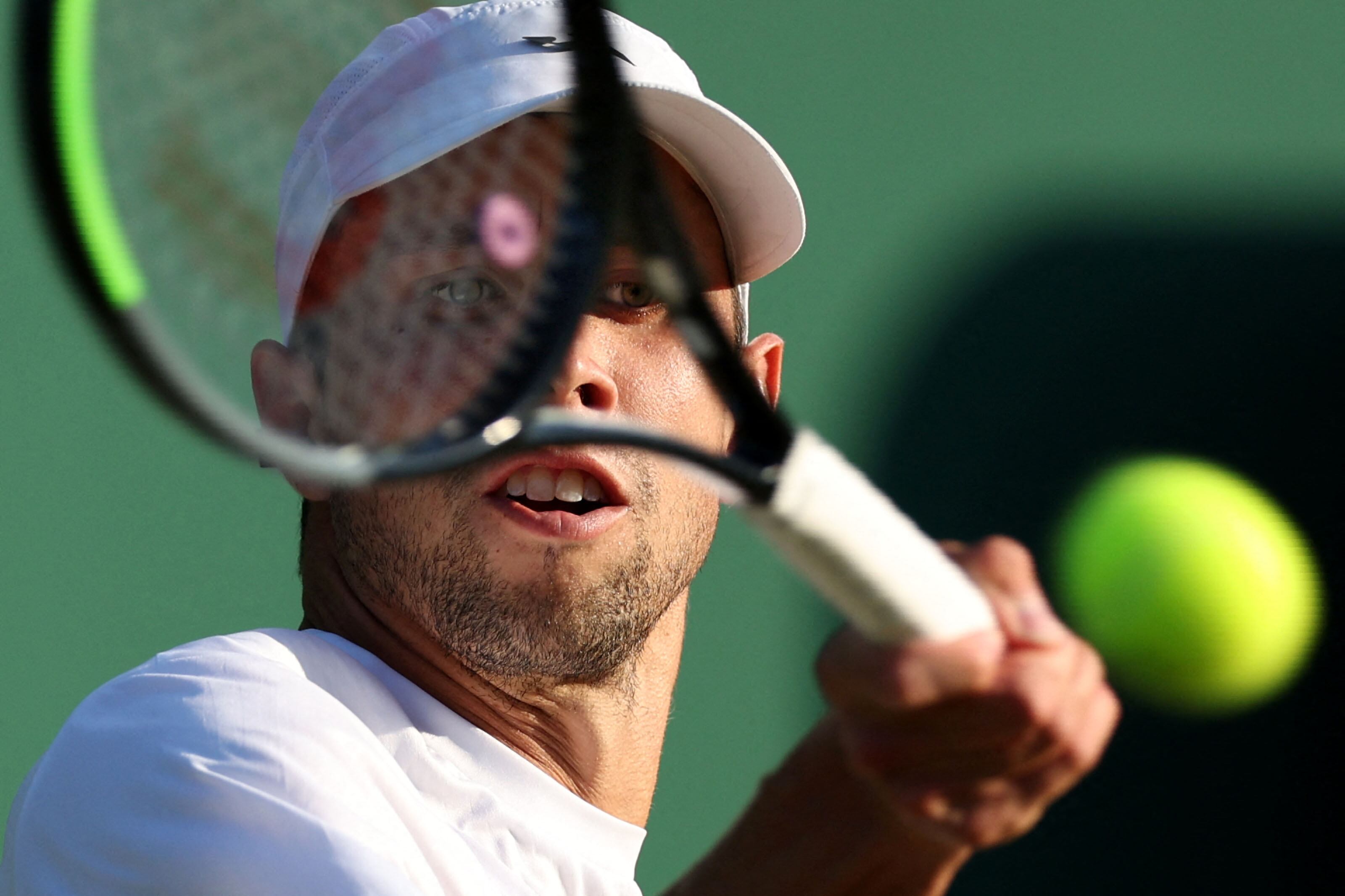 Colombia's Daniel Elahi Galan returns the ball to Sweden's Mikael Ymer during their men's singles tennis match on the fifth day of the 2023 Wimbledon Championships at The All England Tennis Club in Wimbledon, southwest London, on July 7, 2023. (Photo by Adrian DENNIS / AFP) / RESTRICTED TO EDITORIAL US