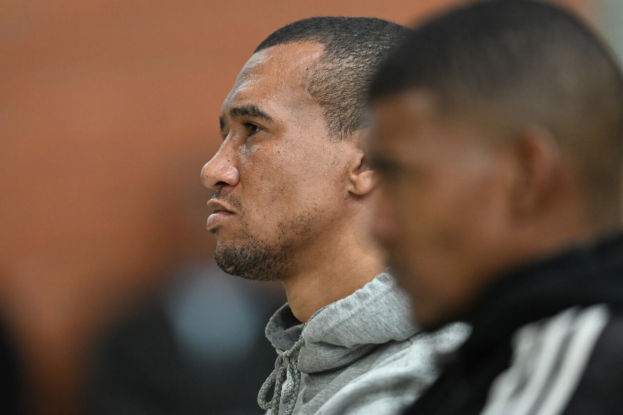 Jacquen Appollis (L) and Steveno van Rhyn (R) and their unseen co-accused Racquel "Kelly" Smith listen to proceedings in court in Saldanha Bay on May 29, 2025 where they will receive their sentences after they were found guilty of kidnapping and human trafficking of her missing child Joshlin Smith. (Photo by RODGER BOSCH / AFP)