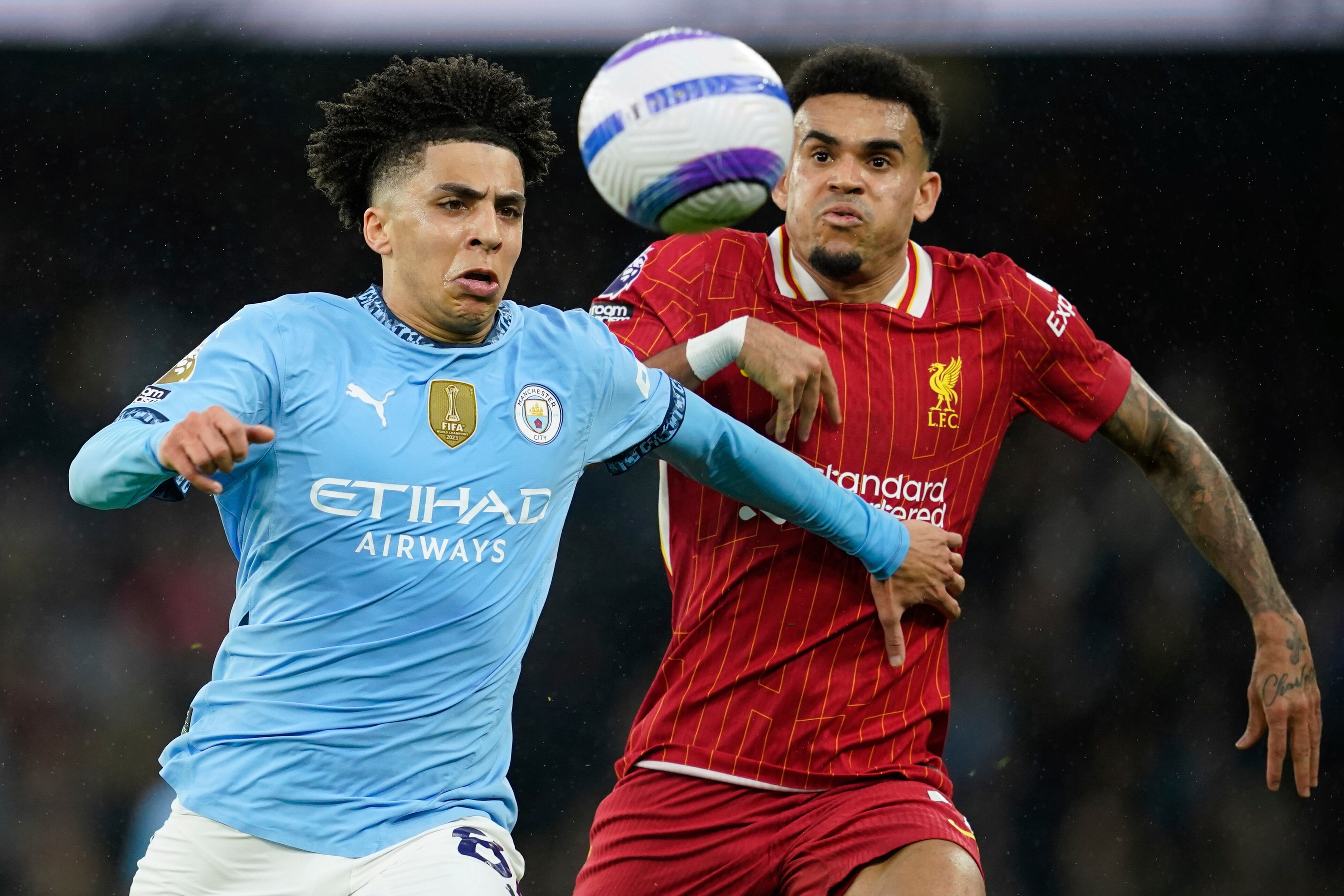 Manchester City's Rico Lewis, left, and Liverpool's Luis Diaz vie for the ball during the English Premier League soccer match between Manchester City and Liverpool at Etihad stadium in Manchester, England, Sunday, Feb. 23, 2025. (AP Photo/Dave Thompson)