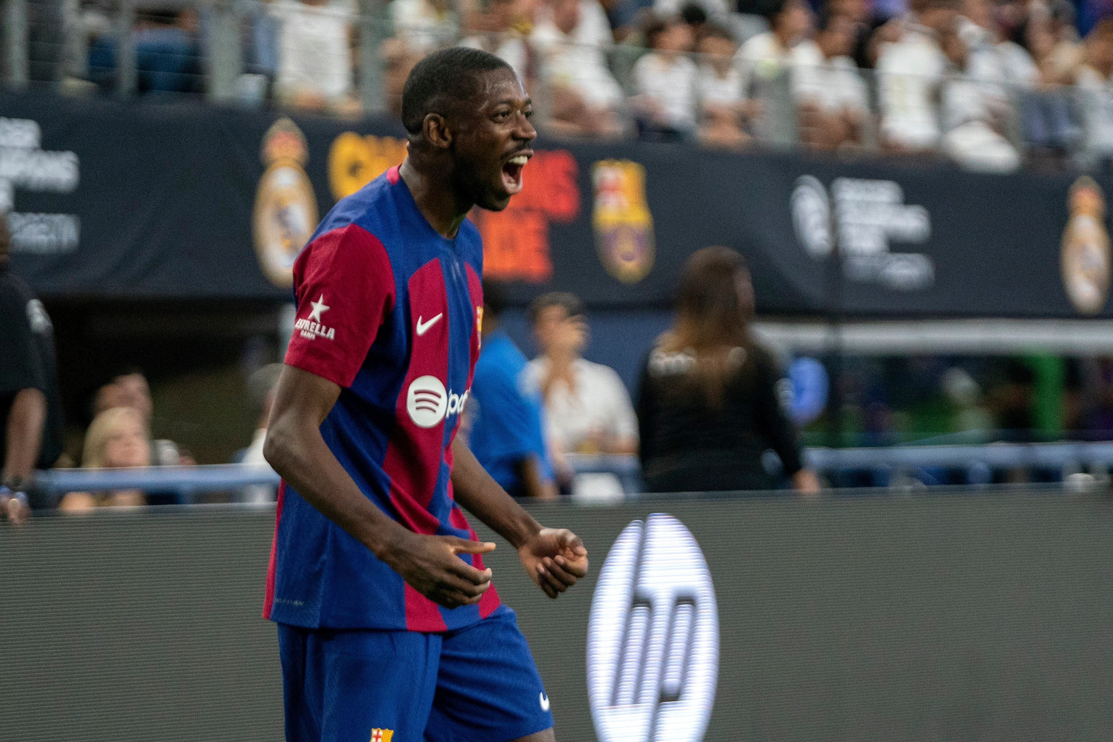 FC Barcelona forward Ousmane Dembele celebrates a goal against Real Madrid during the first half of a Champions Tour soccer match, Saturday, July 29, 2023 at AT&T Stadium in Arlington, Texas. (AP Photo/Jeffrey McWhorter)