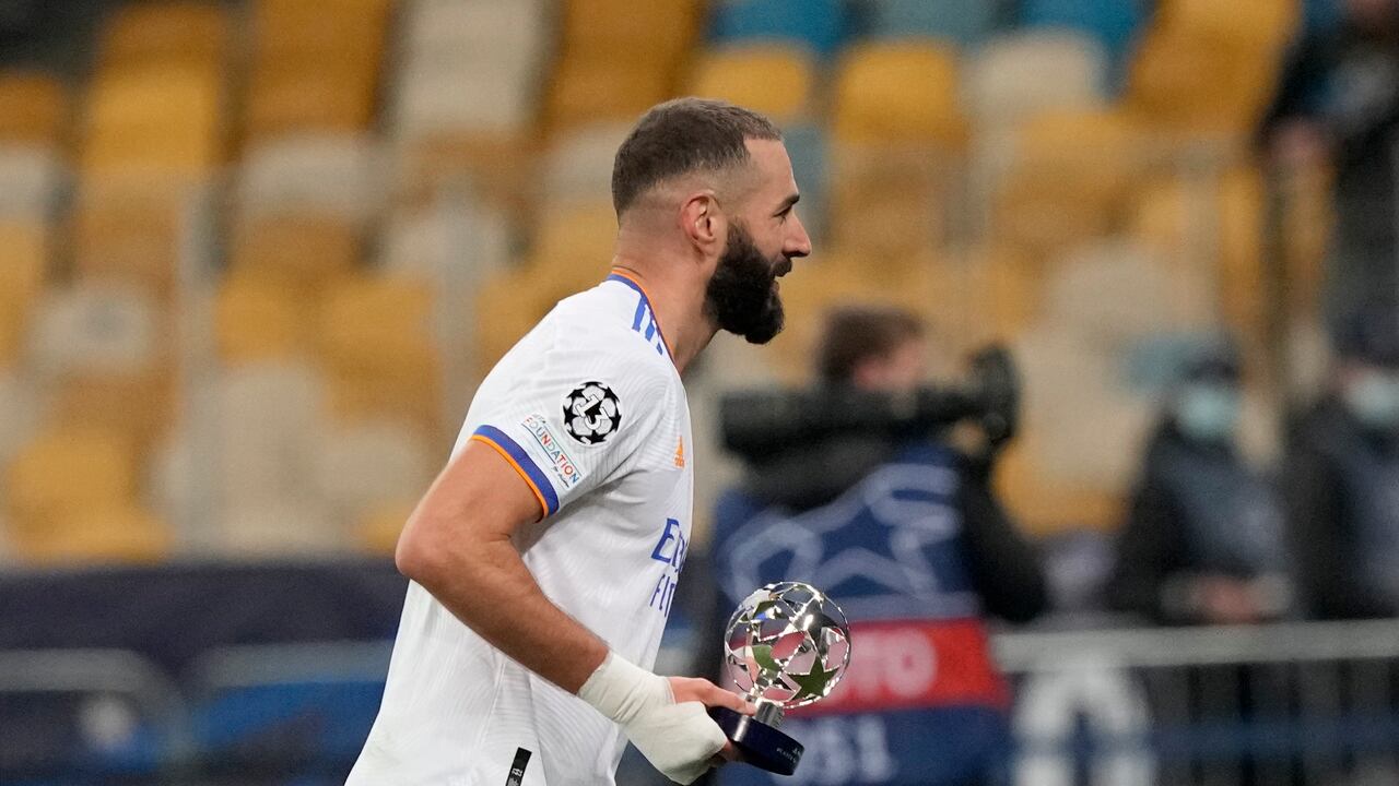 Real Madrid's Karim Benzema holds the trophy as best player after the Champions League group D soccer match between Shakhtar Donetsk and Real Madrid at the Olympiyskiy stadium in Kyiv, Ukraine, Tuesday, Oct. 19, 2021. (AP Photo/Efrem Lukatsky)