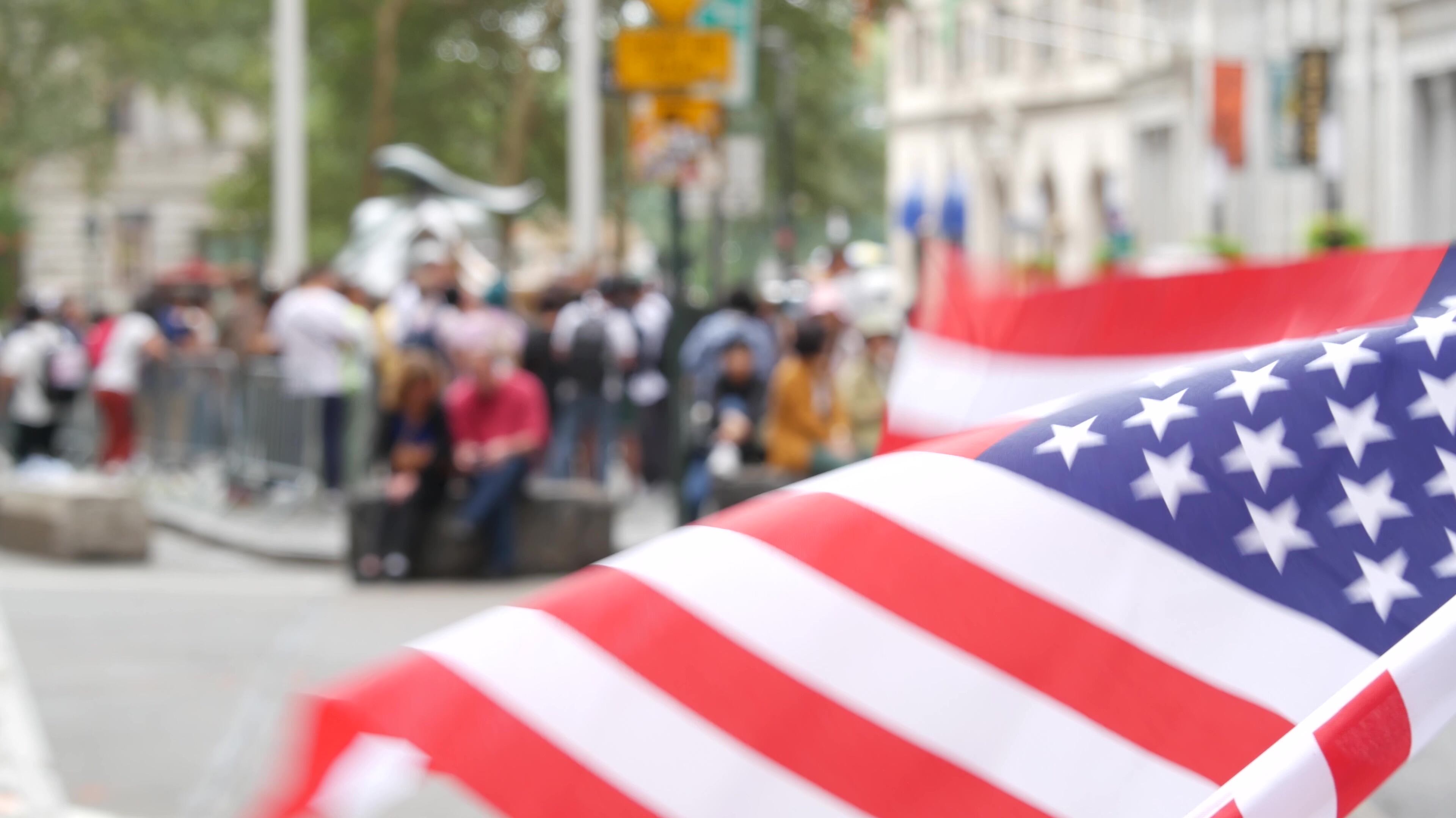 New York City Charging Bull, Wall street Stock Exchange symbol in USA. Lower Manhattan Downtown Financial District, United States. American Flag on Broadway street. Defocused tourist people. Landmark.