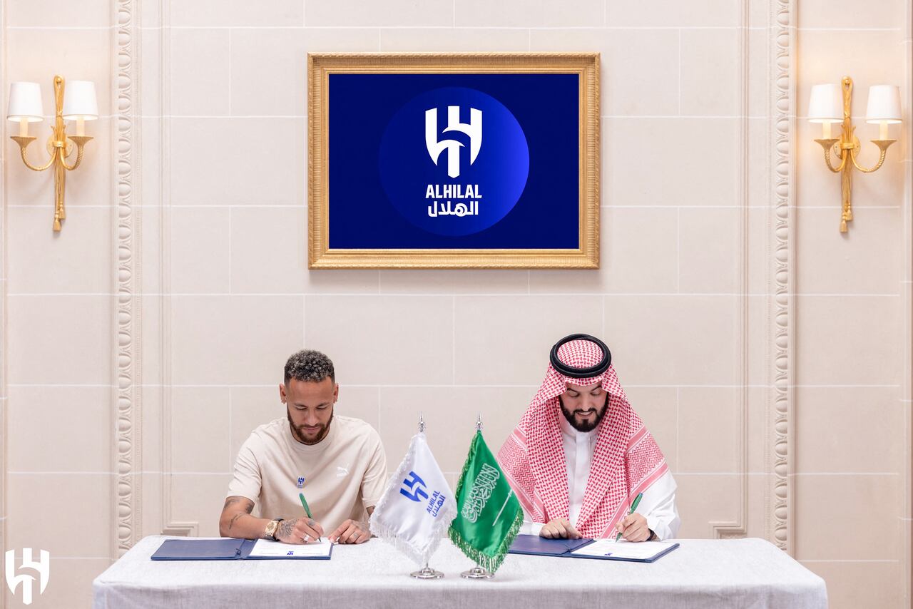 In this handout picture released by the Saudi Al-Hilal football club on August 15, 2023, Brazilian forward Neymar (L) signs a contract together with Hilal President Fahad bin Nafel in Paris. Brazil forward Neymar has signed for Saudi Arabia's Al-Hilal from Paris Saint-Germain, the clubs announced today, joining Cristiano Ronaldo and Karim Benzema as the latest big name lured to the oil-rich Gulf state. (Photo by Saudi Pro League / AFP) / �The erroneous mention[s] appearing in the metadata of this photo by - has been modified in AFP systems in the following manner: [in Paris] instead of [in Riyadh]. Please immediately remove the erroneous mention[s] from all your online services and delete it (them) from your servers. If you have been authorized by AFP to distribute it (them) to third parties, please ensure that the same actions are carried out by them. Failure to promptly comply with these instructions will entail liability on your part for any continued or post notification usage. Therefore we thank you very much for all your attention and prompt action. We are sorry for the inconvenience this notification may cause and remain at your disposal for any further information you may require.�