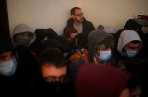 Supporters surround rap singer Pablo Hasél as police officers arrive to arrest him at the University of Lleida, Spain, Tuesday, Feb. 16, 2021. A rapper in Spain and dozens of his supporters have locked themselves inside a university building in the artist's latest attempt to avoid a prison sentence for insulting the monarchy and praising terrorism. (AP Photo/Joan Mateu)