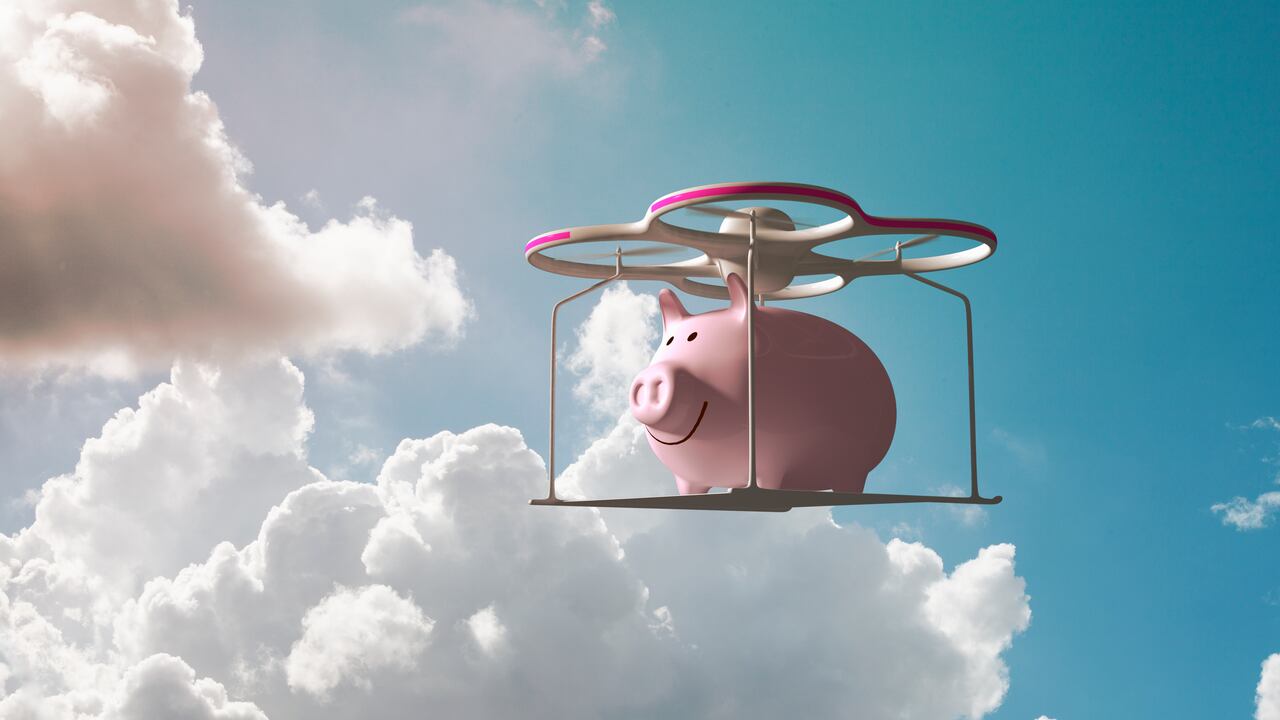 Piggy bank flying in the sky on a drone