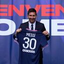 Lionel Messi holds his jersey after a press conference Wednesday, Aug. 11, 2021 at the Parc des Princes stadium in Paris. Lionel Messi said he's been enjoying his time in Paris "since the first minute" after he signed his Paris Saint-Germain contract on Tuesday night. The 34-year-old Argentina star signed a two-year deal with the option for a third season after leaving Barcelona. (AP Photo/Francois Mori)