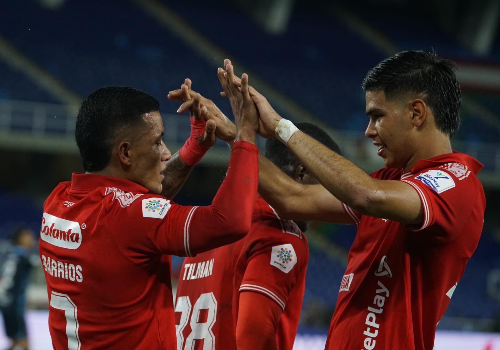 Cristian Barrios celebra el tercer gol de América con José Cavadía.
