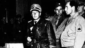 File picture dated 1945, showing Nazi SS - Standartenfuhrer Walter Rauff , center, shortly after being arrested at the Regina Hotel in Milano, Italy, January 21, 1984. Rauff, who is the object of a warrant for arrest issued in March 1961 by the Hanover Attorney general for the murder of more than 97,000 Jews by mobile gas vans, lives in Chile ever since the fifties. Nazi criminal hunter Serge Klarsfeld' s wife, Beate Klarsfeld, arrived Thursday in Santiago, Chile, to try to obtain Rauff's expulsion and for this to condut a public and media campaign in Chile. (AP Photo)