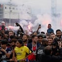 Paris-Saint Germain supporters celebrate afterLionel Messi arrived at Le Bourget airport, north of Paris, Tuesday, Aug. 10, 2021. Lionel Messi finalized agreement on his Paris Saint-Germain contract and was flying to France on Tuesday to complete the move that confirms the end of a career-long association with Barcelona. (AP Photo/Francois Mori)