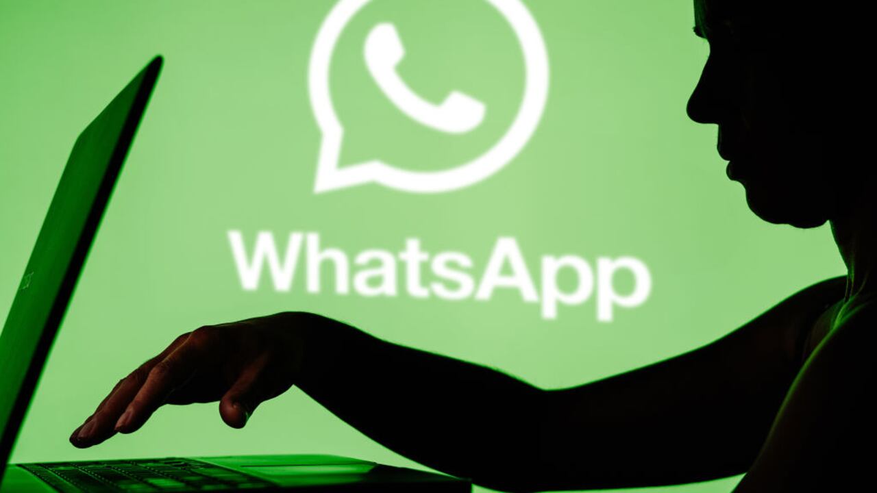 BRAZIL - 2024/03/27: In this photo illustration, the WhatsApp logo is seen in the background and a silhouette of a person using a notebook. (Photo Illustration by Rafael Henrique/SOPA Images/LightRocket via Getty Images)