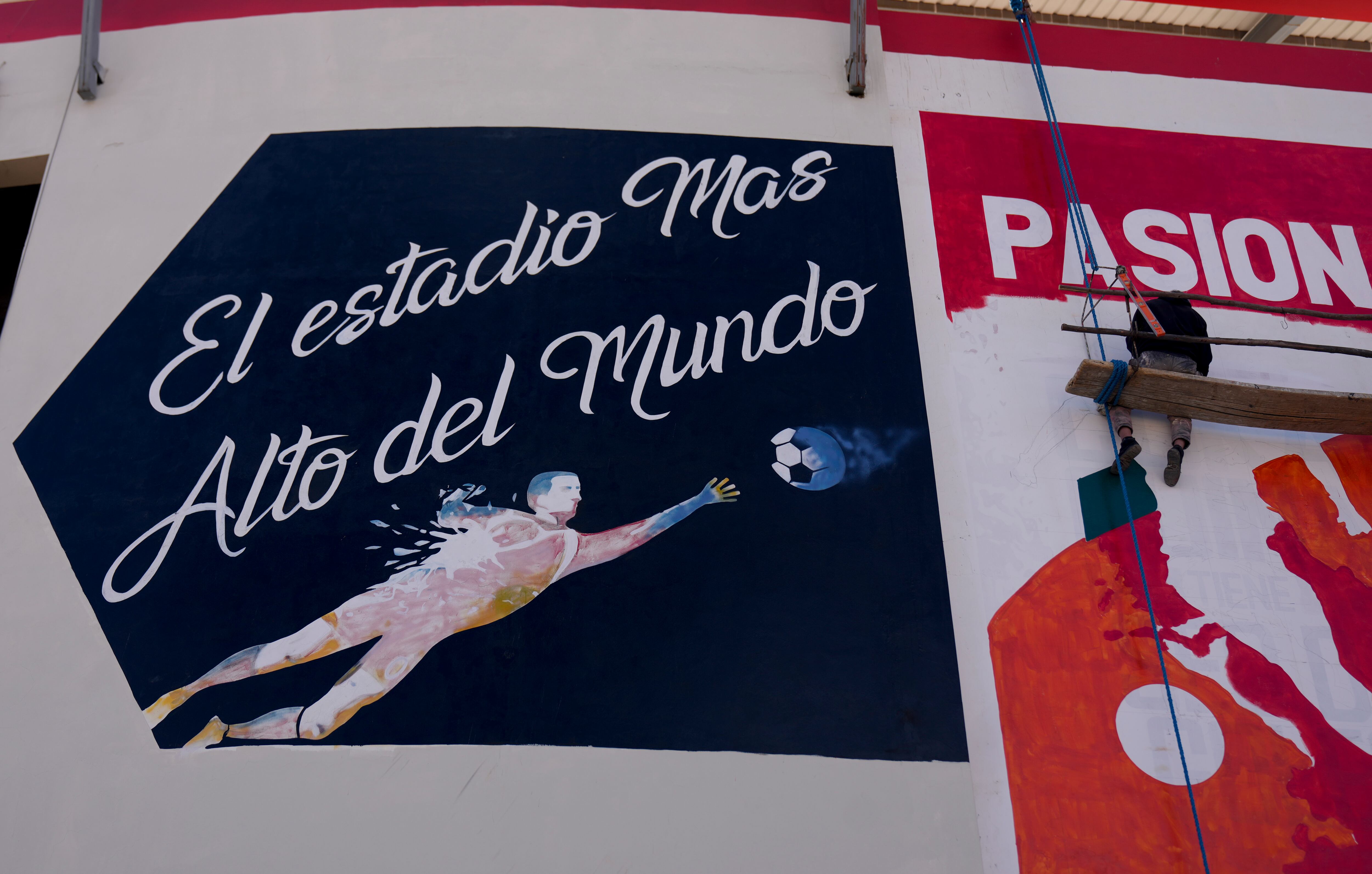 A mural at the Municipal Villa Ingenio stadium reads in Spanish "The highest stadium in the world" in El Alto, Bolivia, Thursday, Aug. 29, 2024. (AP Photo/Juan Karita)