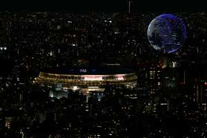Drones flying over the National Stadium during the opening ceremony of 2020 Tokyo Olympics is seen from Shibuya Sky observation deck Friday, July 23, 2021, in Tokyo, Japan. (AP Photo/Eugene Hoshiko)