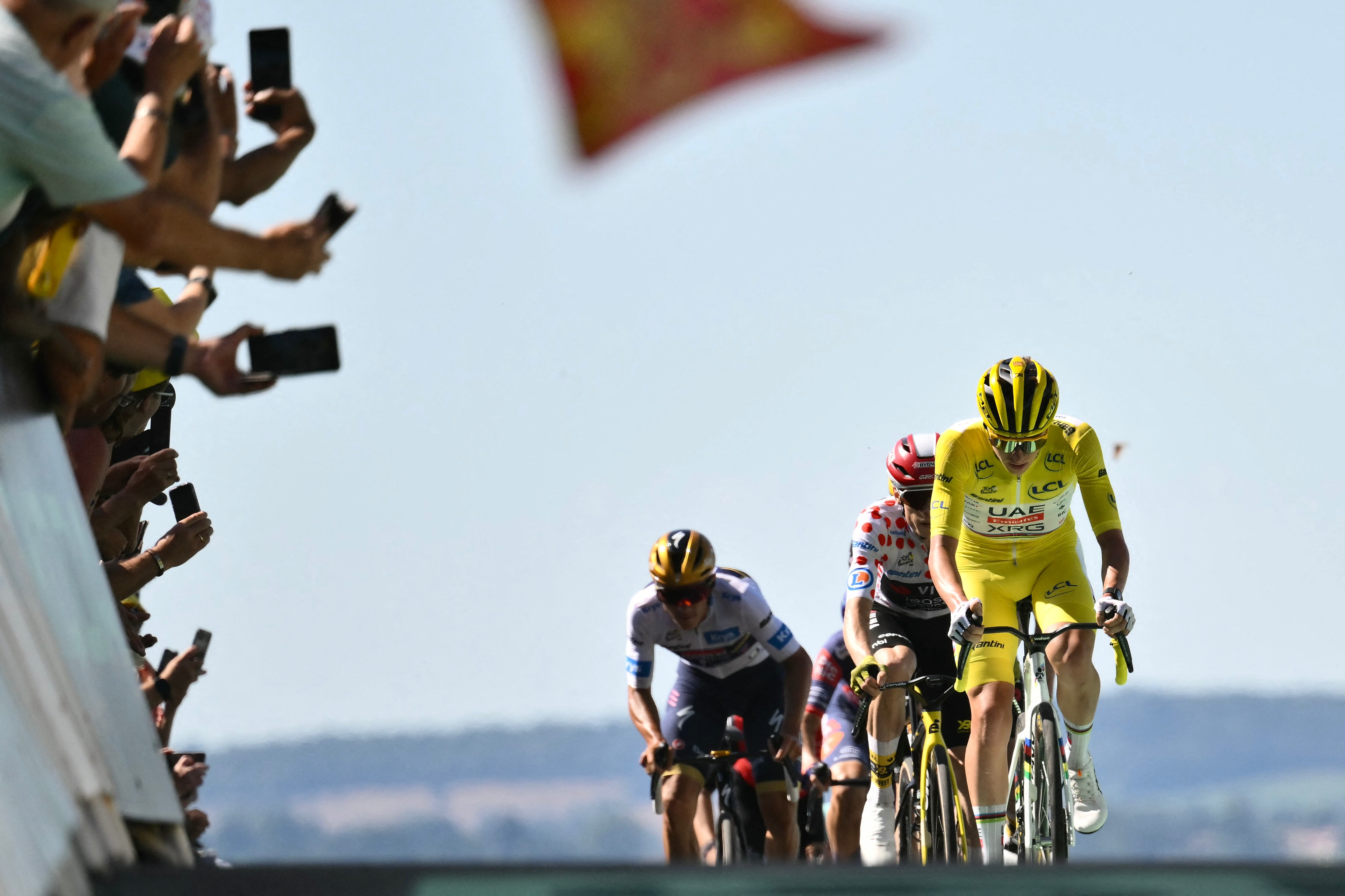 UAE Team Emirates - XRG team's Slovenian rider Tadej Pogacar wearing the overall leader's yellow jersey cycles to the finish line of the 6th stage of the 112th edition of the Tour de France cycling race, 201.5 km between Bayeux and Vire Normandie, Northwestern France, on July 10, 2025. (Photo by Marco BERTORELLO / AFP)