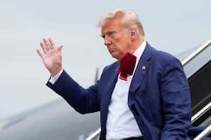 Former President Donald Trump waves as he steps off his plane at Ronald Reagan Washington National Airport, Thursday, Aug. 3, 2023, in Arlington, Va., as he heads to Washington to face a judge on federal conspiracy charges alleging Trump conspired to subvert the 2020 election. (AP Photo/Alex Brandon)