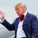 Former President Donald Trump waves as he steps off his plane at Ronald Reagan Washington National Airport, Thursday, Aug. 3, 2023, in Arlington, Va., as he heads to Washington to face a judge on federal conspiracy charges alleging Trump conspired to subvert the 2020 election. (AP Photo/Alex Brandon)