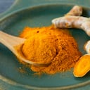 Turmeric root and turmeric powder , close up