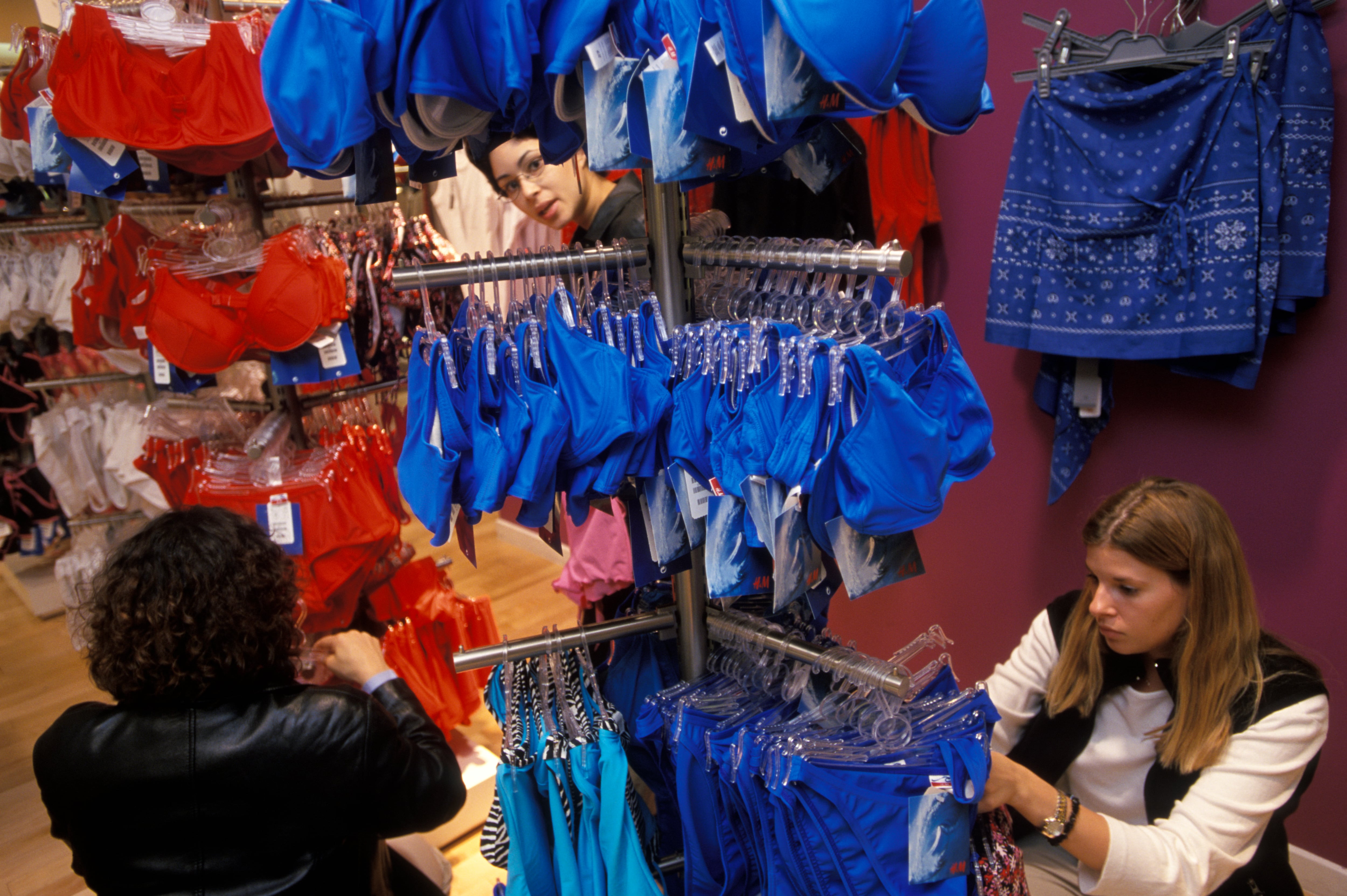 Women browse through racks of colorful lingerie at the new H&M store in Manhattan. (Photo by James Leynse/Corbis via Getty Images)