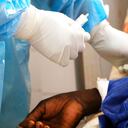 Dr. Dieudonne Wend-Kuni Kientega tends to a COVID-19 patient at Ouagadougou's Bogodogo Medical Teaching Hospital Thursday Feb. 4, 2021. Since November, the conflict-riddled West African nation of Burkina Faso faces a much deadlier second coronavirus wave than the first and health officials worry a lack of knowledge and adherence to coronavirus measures is making it hard to rein in. (AP Photo/Sam Mednick)