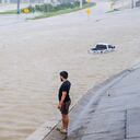 HOUSTON, TEXAS - JULY 08: A person looks out towards the flooded interstate after Hurricane Beryl swept through the area on July 08, 2024 in Houston, Texas. Tropical Storm Beryl developed into a Category 1 hurricane as it hit the Texas coast late last night. (Photo by Brandon Bell/Getty Images)