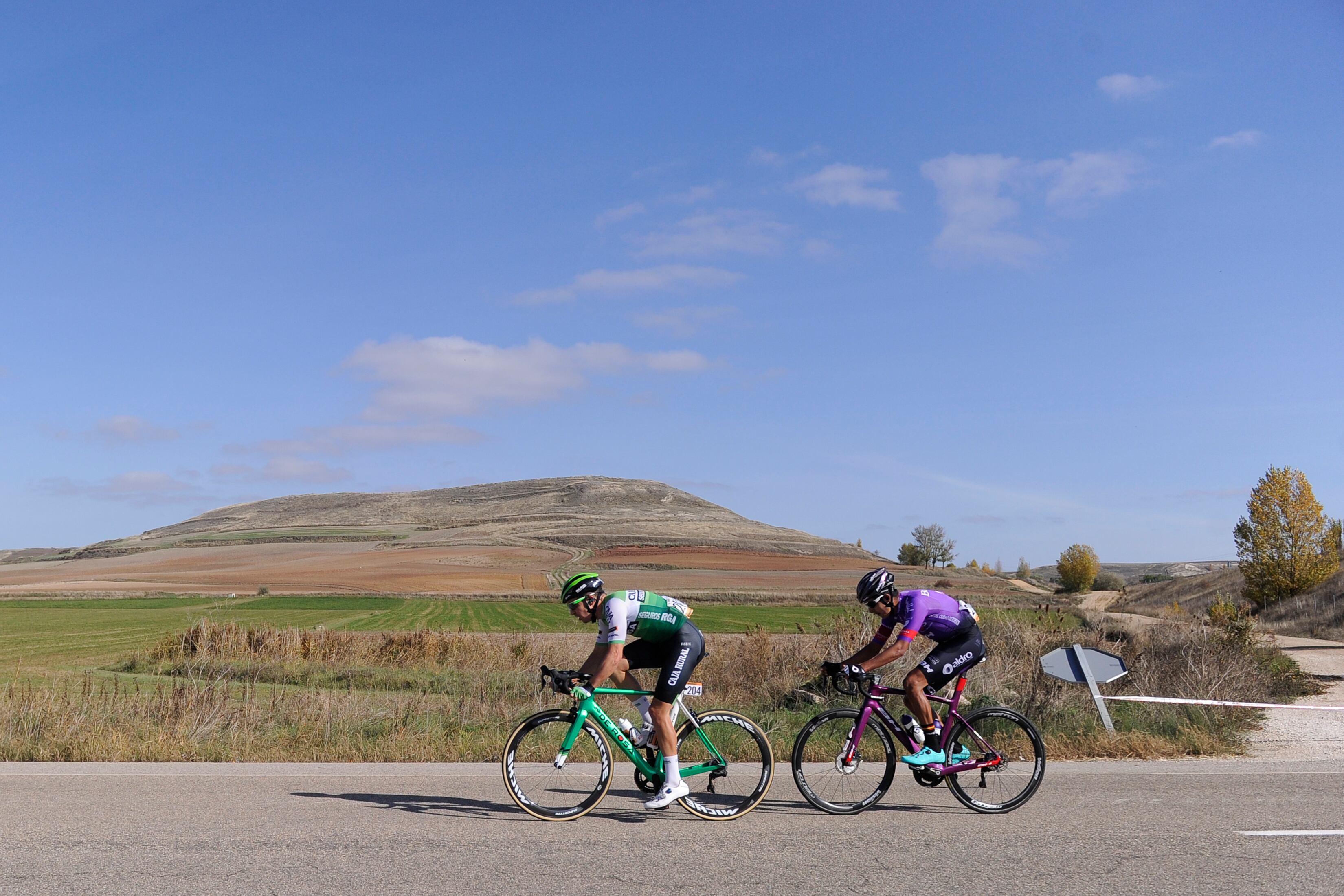 A couple of cyclists ride during the 9th stage of the 2020 La Vuelta cycling tour of Spain, a 157,7-km race from Castrillo del Val to Aguilar de Campoo, on October 29, 2020. (Photo by ANDER GILLENEA / AFP)