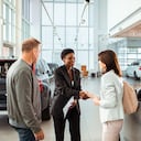 Close up of a couple picking up their new car at the dealership
