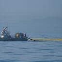 Un barco con Marine Spill Response Corporation (MSRC), una organización de eliminación de derrames de petróleo (OSRO), despliega barreras flotantes conocidas como barreras para tratar de detener una mayor incursión de una marea negra en Huntington Beach, California. Foto AP / Ringo H.W. Chiu