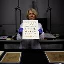 Israel Antiquities Authority conservator Tanya Bitler shows newly discovered Dead Sea Scroll fragments at the Dead Sea scrolls conservation lab in Jerusalem, Tuesday, March 16, 2021. Israeli archaeologists on Tuesday announced the discovery of dozens of new Dead Sea Scroll fragments bearing a biblical text found in a desert cave and believed hidden during a Jewish revolt against Rome nearly 1,900 years ago. (AP Photo/Sebastian Scheiner)