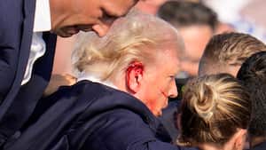 Republican presidential candidate former President Donald Trump is helped off the stage at a campaign event in Butler, Pa., on Saturday, July 13, 2024. (AP Photo/Gene J. Puskar)