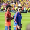 Colombian national team players Radamel Falcao (R) and Juan Cuadrado enter the field during their welcoming ceremony at El Campin stadium in Bogota on July 5, 2018, after their participation in the FIFA World Cup. England beat Colombia in a dramatic penalty shootout in Moscow on July 3 to reach the World Cup quarter-finals. (Photo by Raul ARBOLEDA / AFP)
