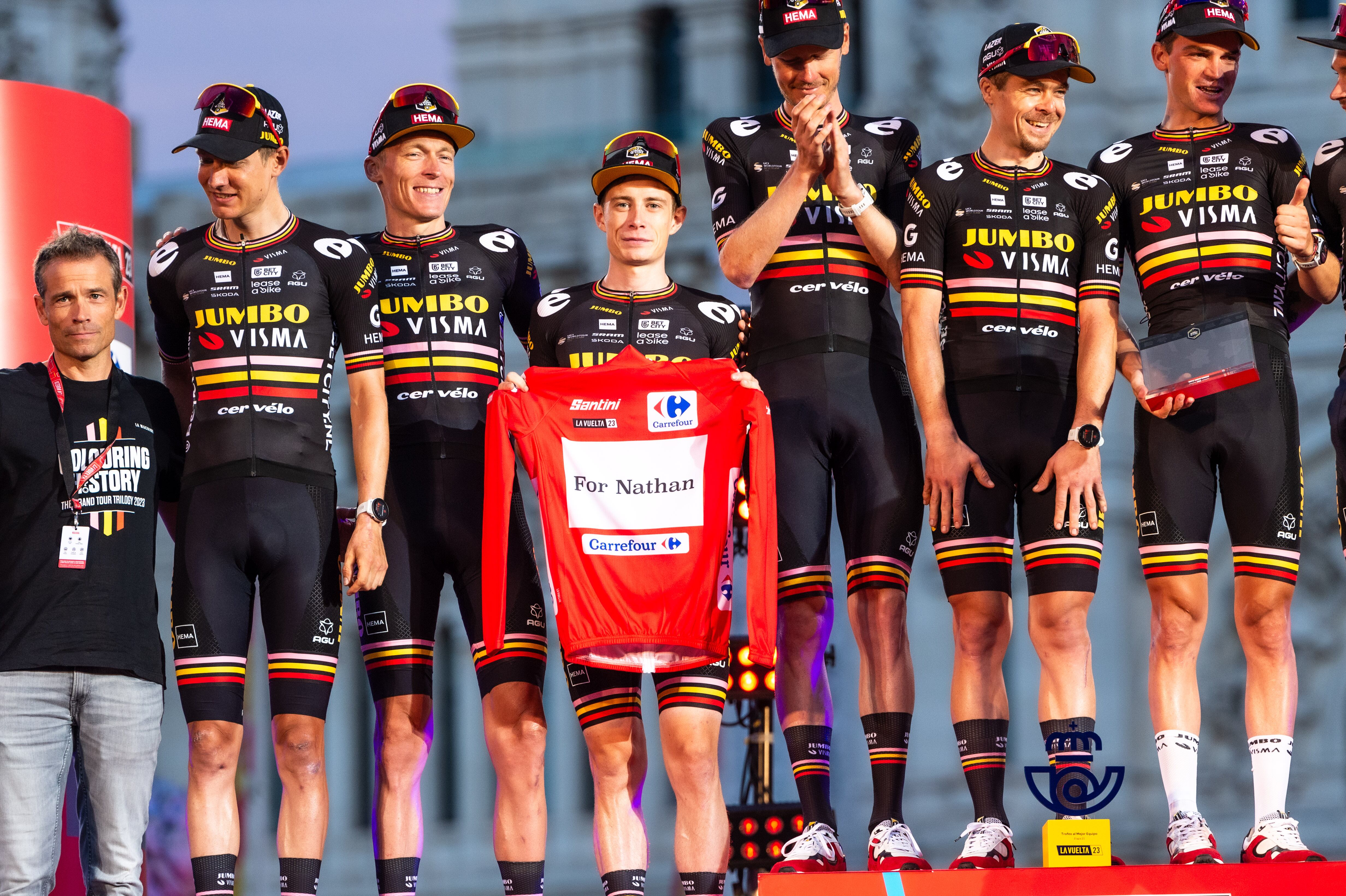 MADRID, SPAIN - 2023/09/17: The Jumbo Visma Team (from L to R) Wilco Kelderman, Robert Gesink, Jonas Vingegaard (who shows a jersey in homage to the cyclist Nathan Van Hooydonck), Dylan Van Baarle, Jan Tratnik, Sepp Kuss, is awarded as best team of the Spanish bicycle race La Vuelta at Plaza de Cibeles. (Photo by Alberto Gardin/SOPA Images/LightRocket via Getty Images)