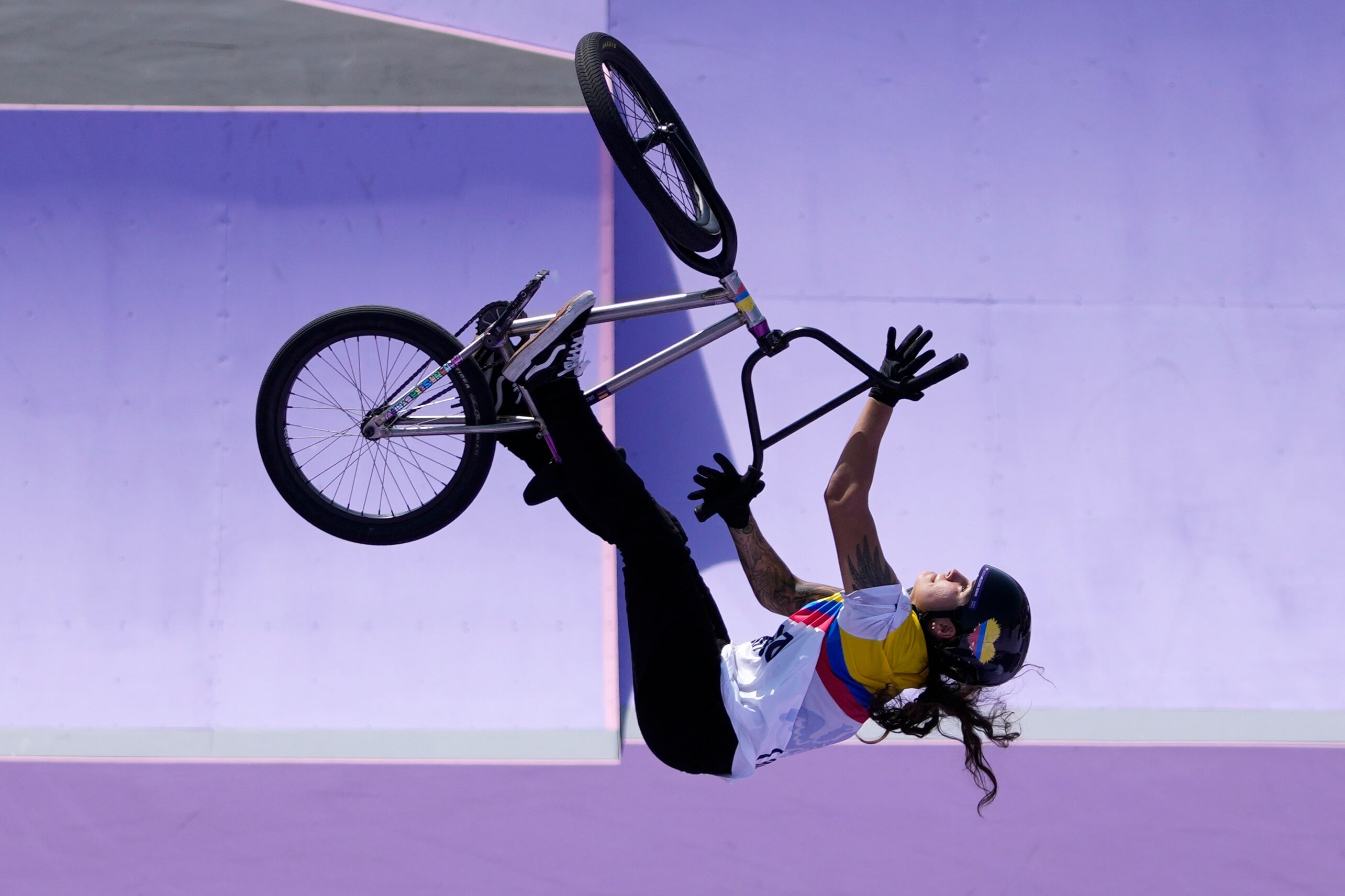 Queen Saray Villegas Serna, of Colombia, performs a trick during the cycling BMX freestyle women's park qualification at the 2024 Summer Olympics, Tuesday, July 30, 2024, in Paris, France. (AP Photo/Frank Franklin II)