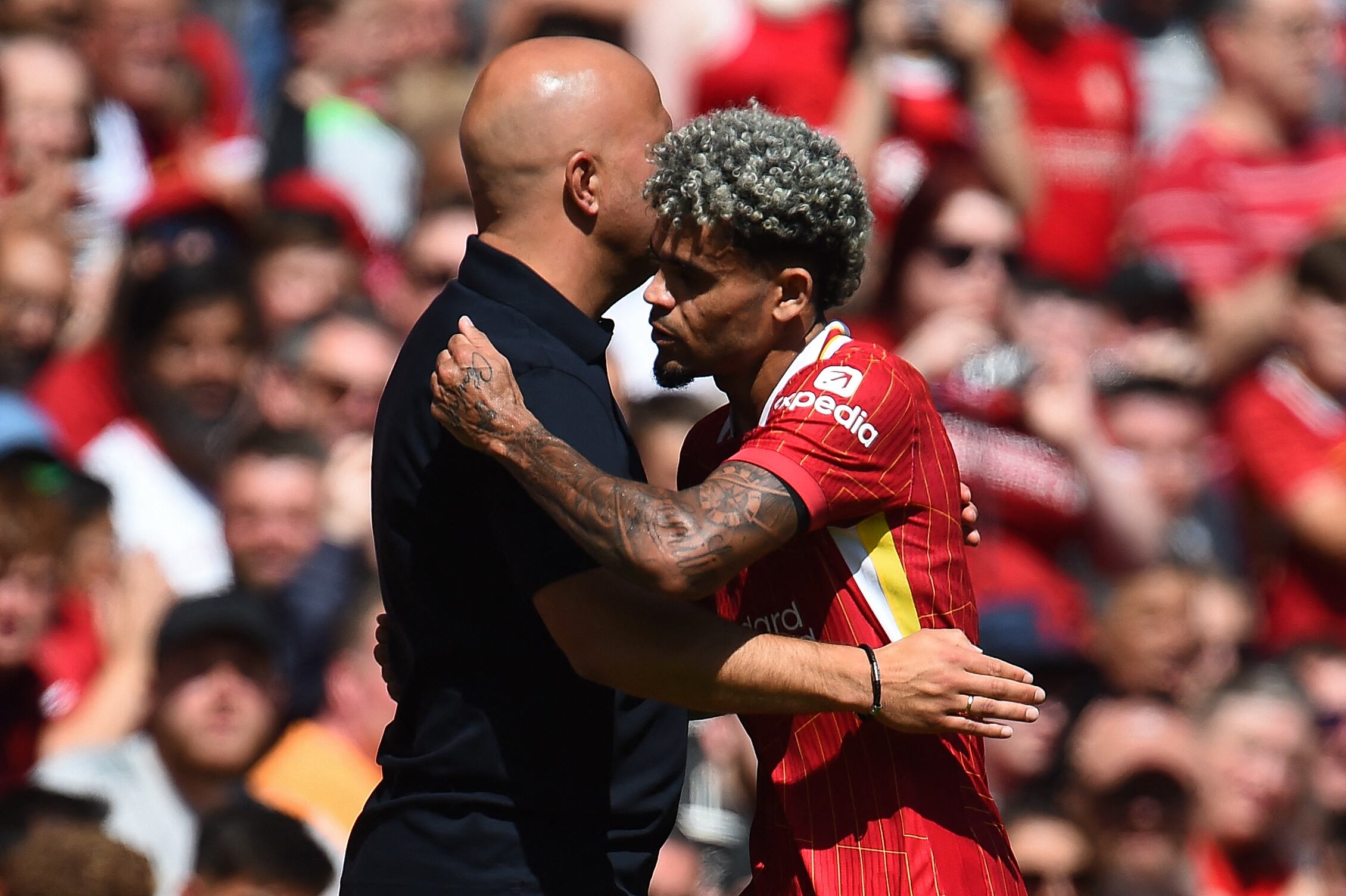 Liverpool's Colombian midfielder #07 Luis Diaz leaves the pitch after being substituted off during the pre-season friendly football match between Liverpool and Sevilla at Anfield stadium in Liverpool, northwest England on August 11, 2024. (Photo by Peter POWELL / AFP)