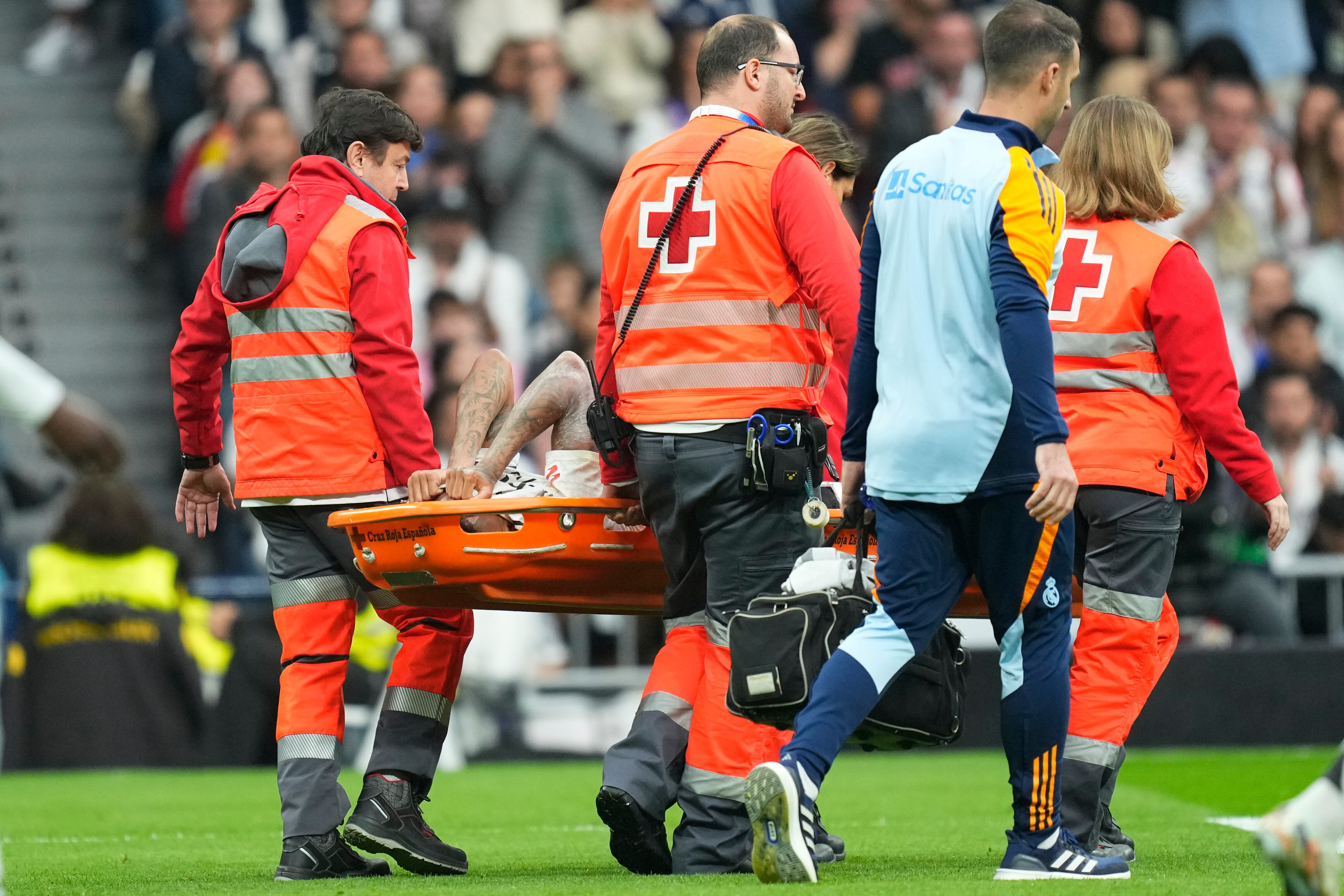 Real Madrid's Eder Militao is stretchered off the pitch after an injury during the Spanish La Liga soccer match between Real Madrid and Osasuna at the Santiago Bernabeu stadium in Madrid, Spain, Saturday, Nov. 9, 2024. (AP Photo/Jose Breton)