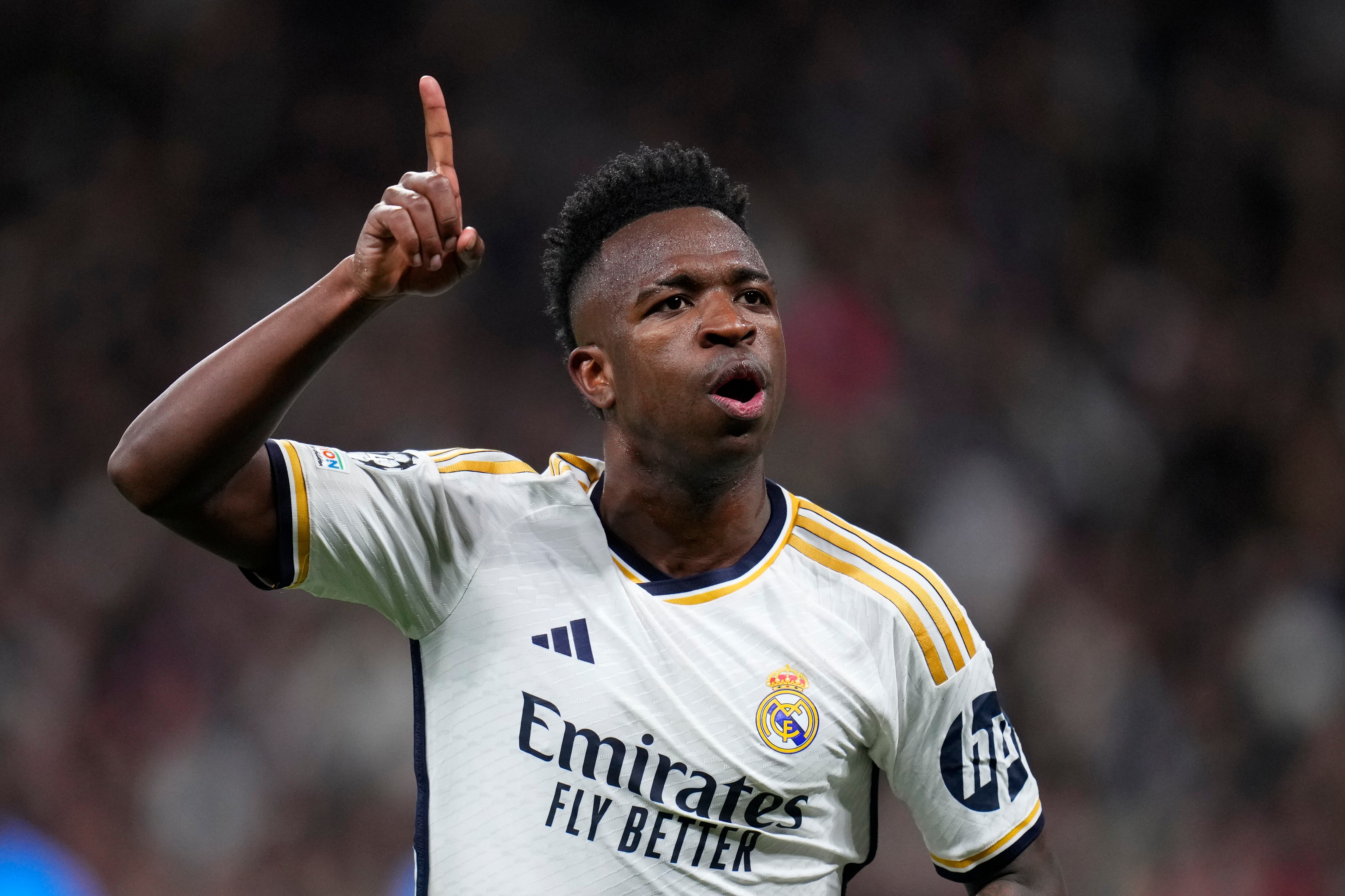FILE - Real Madrid's Vinicius Junior celebrates after scoring his side's opening goal during the Champions League round of 16 second leg soccer match between Real Madrid and RB Leipzig at the Santiago Bernabeu stadium in Madrid, Spain, Wednesday, March 6, 2024. (AP Photo/Manu Fernandez, File)