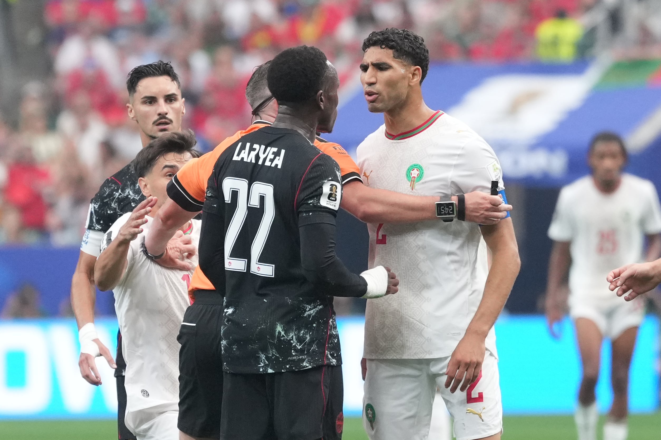 Canada's Richie Laryea, left, and Morocco's Achraf Hakimi argue during the World Cup round of 16 soccer match between Canada and Morocco in Houston, Saturday, July 4, 2026. (AP Photo/Eric Gay)