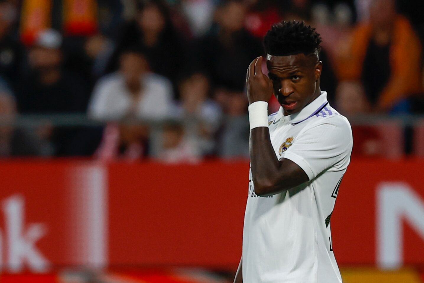 Real Madrid's Vinicius Junior reacts during a Spanish La Liga soccer match between Girona and Real Madrid, at the Montilivi stadium in Girona, Spain, Tuesday, April 25, 2023. (AP Photo/Joan Monfort)