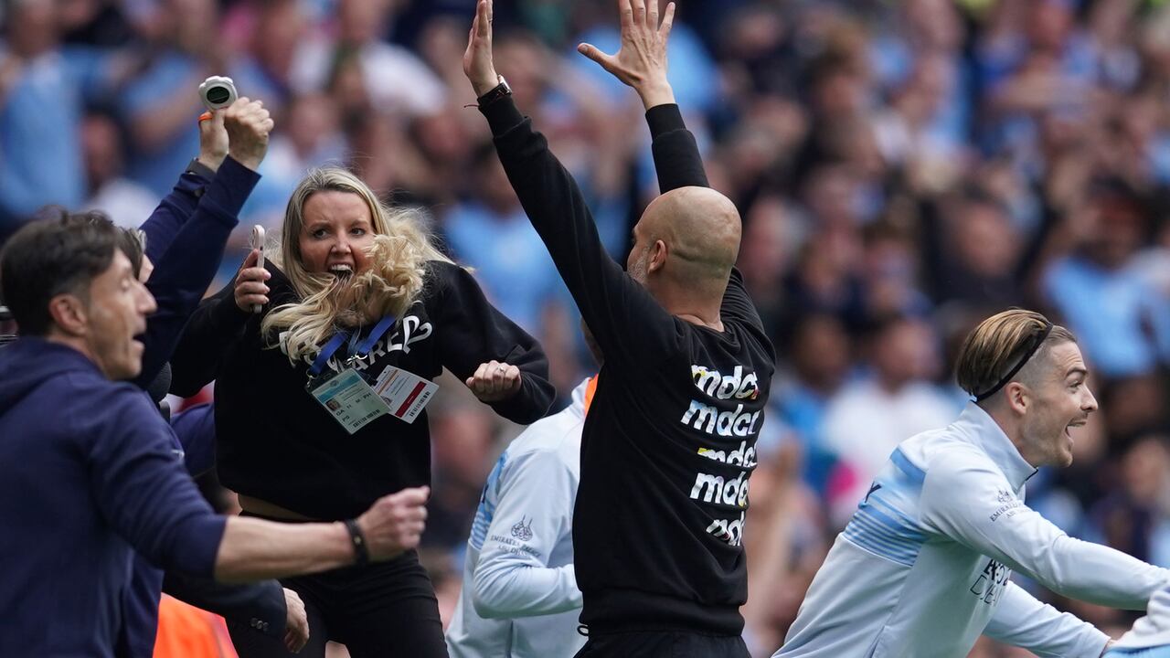 Manchester City's head coach Pep Guardiola and his teammates celebrate after winning the English Premier League soccer match between Manchester City and Aston Villa at the Etihad Stadium in Manchester, England, Sunday, May 22, 2022. Manchester City won the match against Aston Villa and secured the 2022 Premier League title. (AP Photo/Dave Thompson)