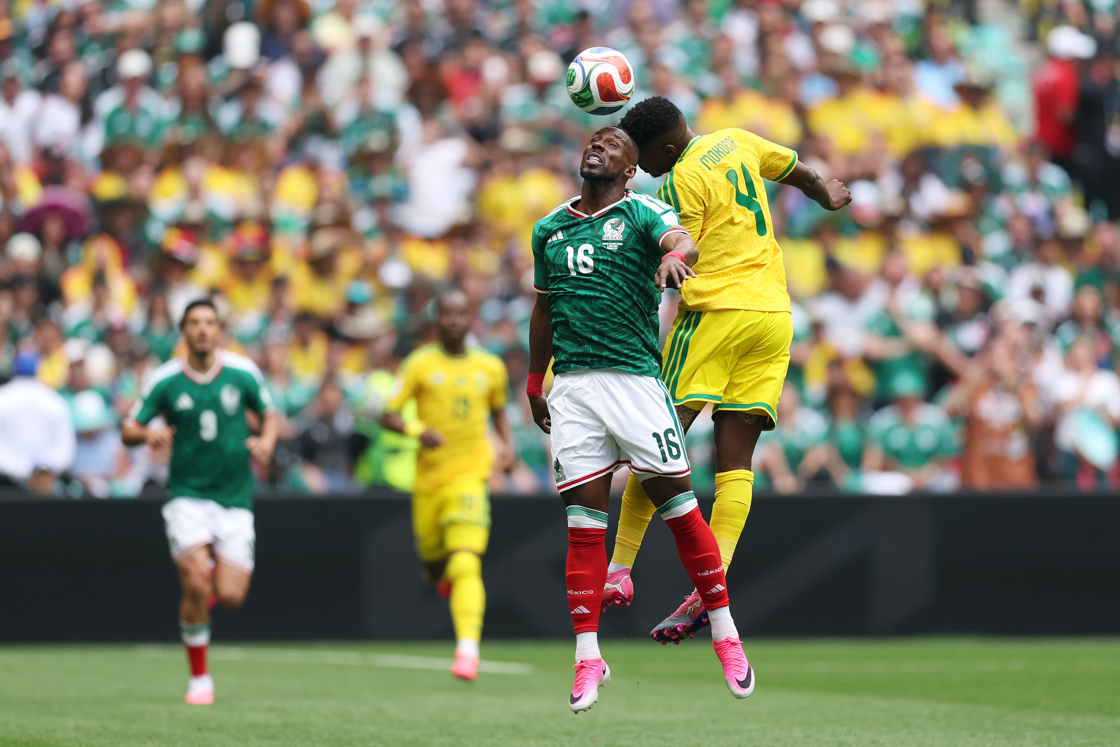 MEXICO CITY, MEXICO - JUNE 11: Julian Quinones #16 of Mexico and Teboho Mokoena #4 of South Africa attempt to head the ball during the FIFA World Cup 2026 Group A match between Mexico and South Africa at Mexico City Stadium on June 11, 2026 in Mexico City, Mexico. (Photo by Luke Hales/Getty Images)