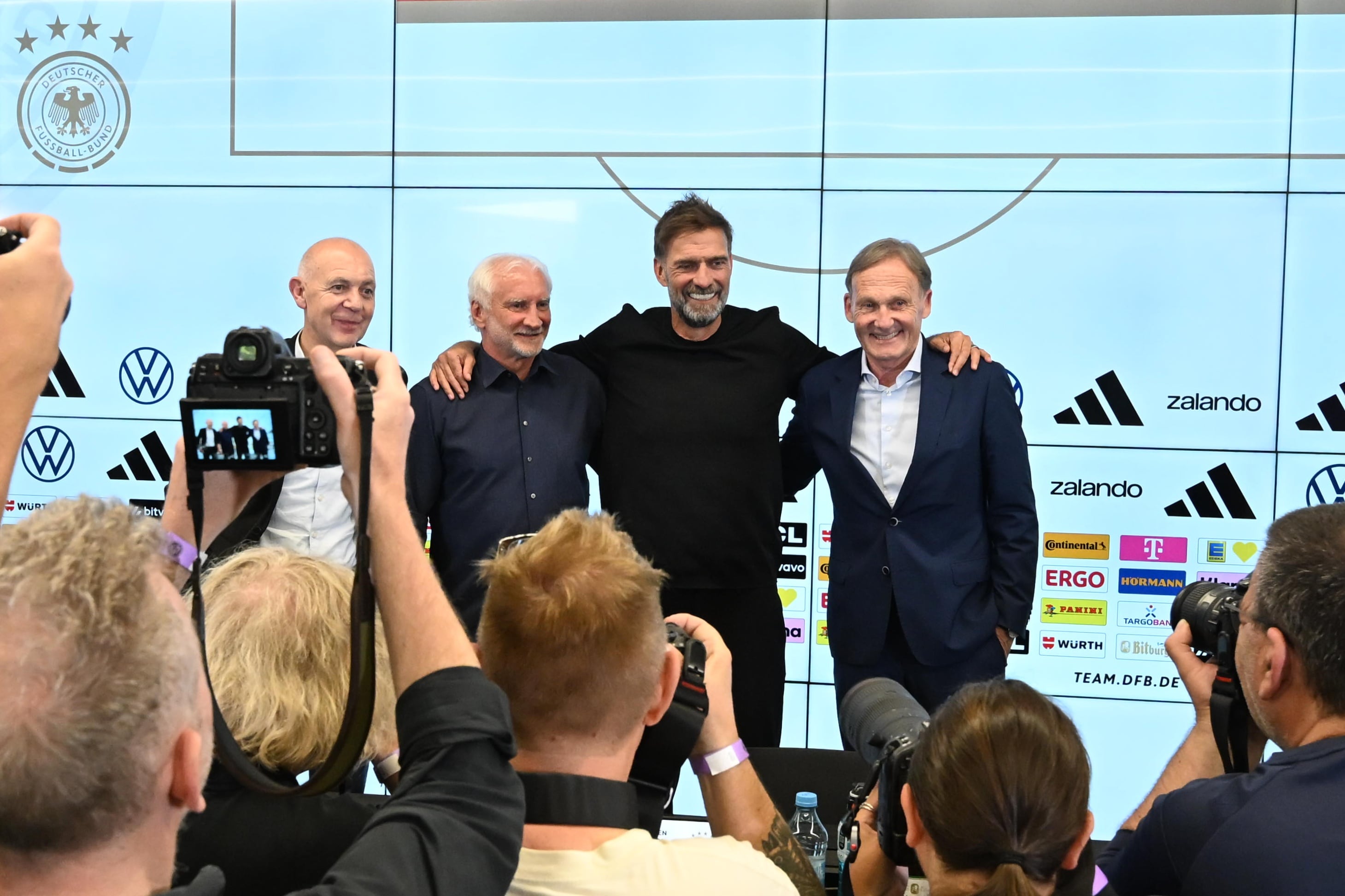 24 July 2026, Hesse, Frankfurt/Main: Soccer, DFB, National Team, Press Conference to Introduce the New National Team Coach, Bernd Neuendorf (left to right), DFB President Rudi Völler, DFB Sports Director Jürgen Klopp, and Hans-Joachim Watzke, DFB Vice President, stand together after a press conference. Photo: Jennifer Brückner/dpa (Photo by Jennifer Brückner/picture alliance via Getty Images)