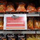 PARIS, FRANCE - JANUARY 05: A sign reading in French in a Carrefour on a shelf for the PepsiCo product Doritos' reads: 'We no longer sell this brand due to unacceptable price increases' at a Carrefour Group store in Montigny-le-Bretonneux, near Paris, France on January 05, 2024. French Multinational retail and wholesaling corporation Carrefour, stop selling PepsiCo products in their stores in four European countries due to prices. (Photo by Mustafa Yalcin/Anadolu via Getty Images)